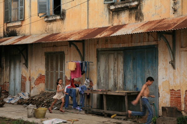 Playing in front of a colonial house, Savannakhet